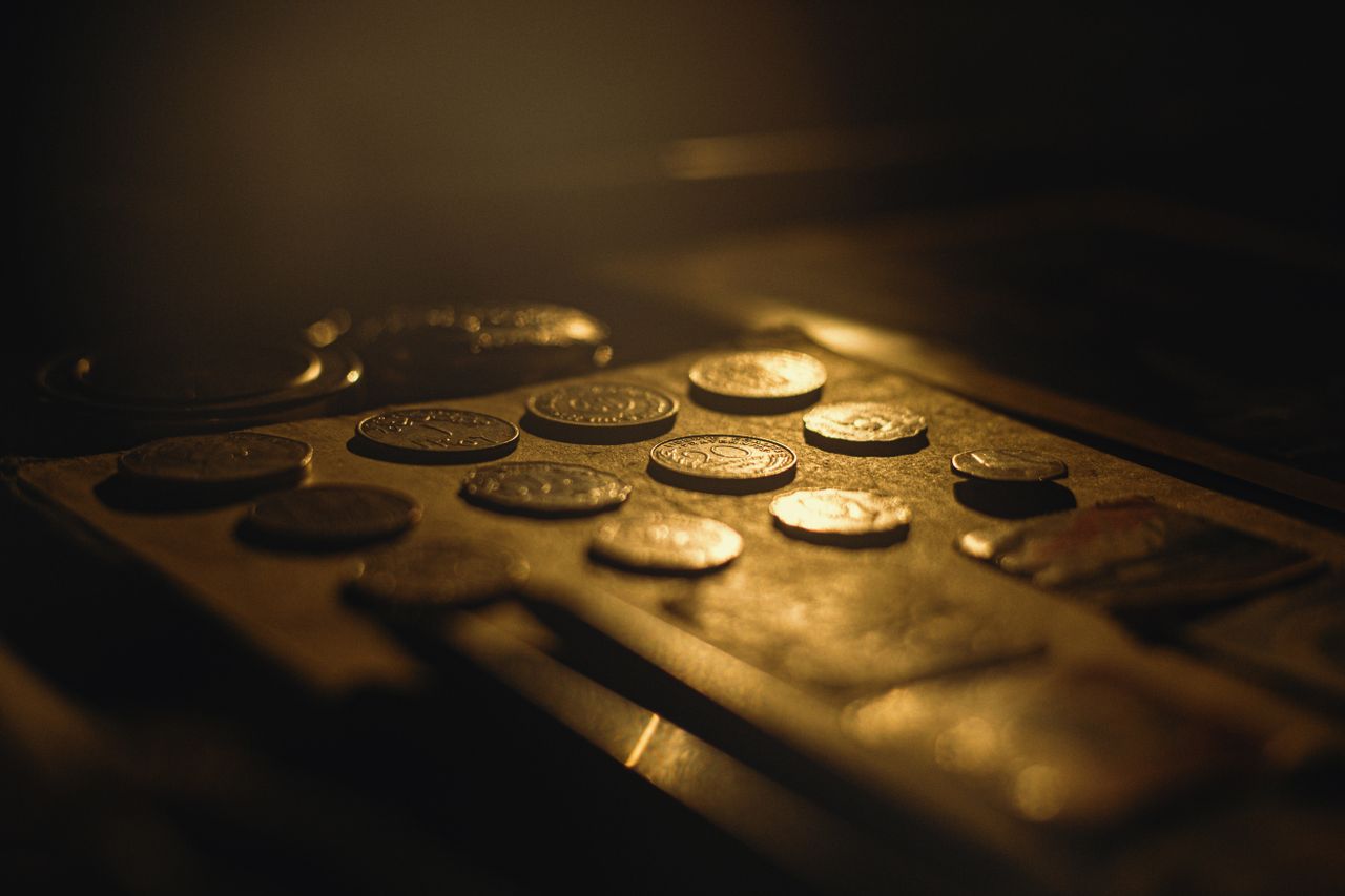 Antique coins in warm light, evaluated for rarity and metal content