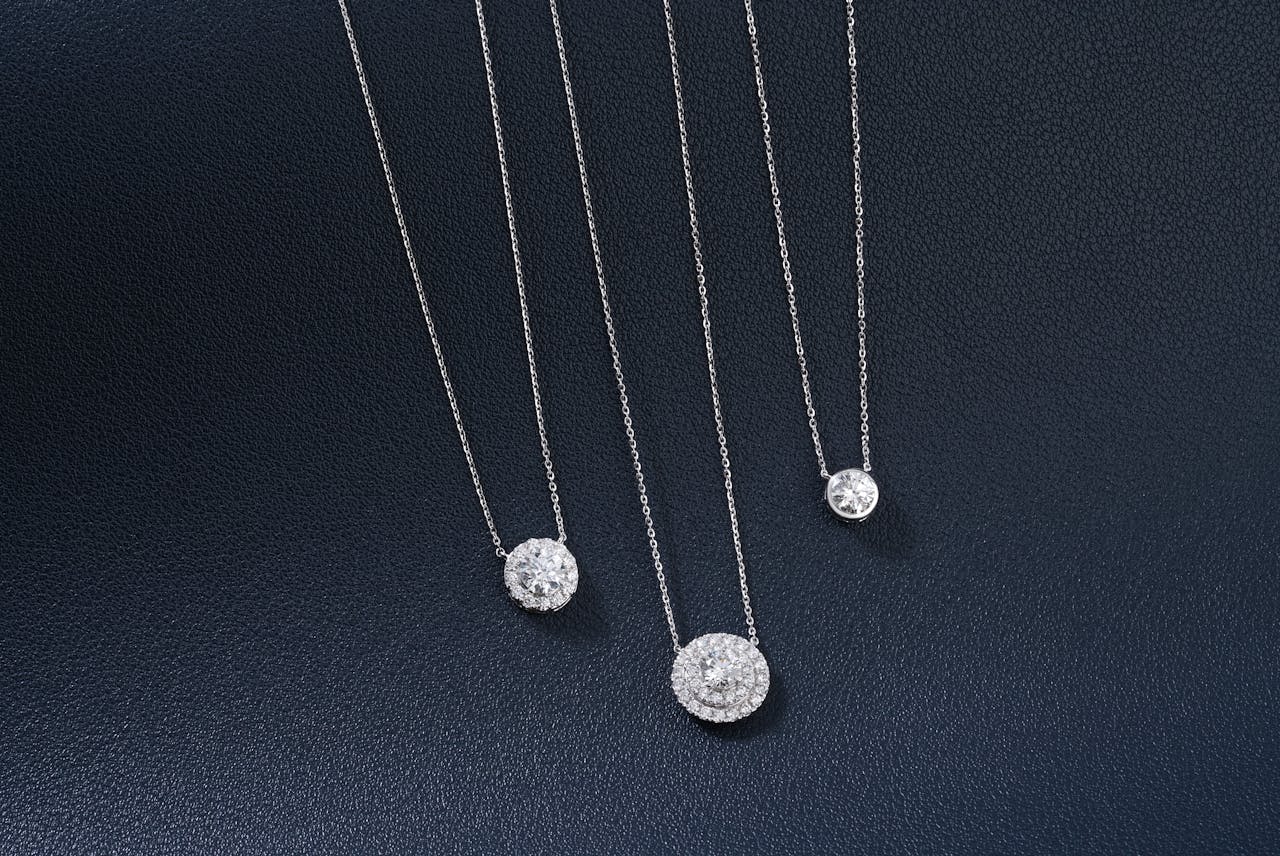 Diamond pendant necklaces displayed before a fine jewelry auction